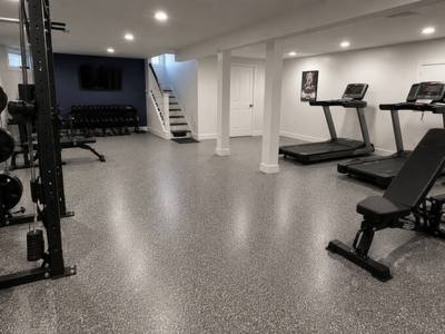 Coated basement slab in a finished home gym