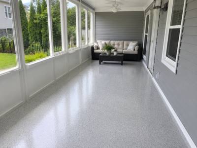 Enclosed porch with a coated floor and the windows in