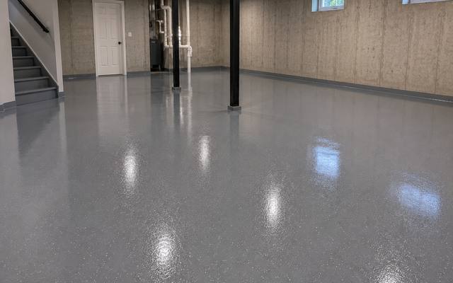 Coated lower level slab in an open finished basement