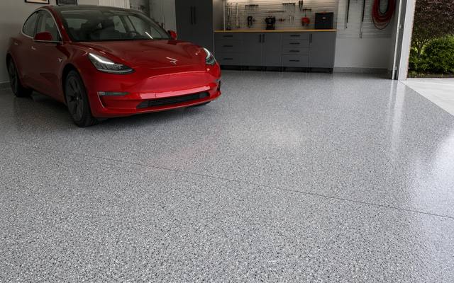 Polyaspartic top coat holding its gloss under a parked vehicle